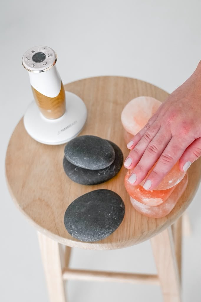 Hot stones and massage tools laid out for a session